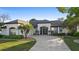 Charming home featuring a well-manicured lawn, elegant black trim, and a welcoming arched entryway with glass doors at 1540 Park Forest Blvd, Mount Dora, FL 32757