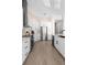 A modern kitchen featuring white cabinets, stainless steel appliances, and light wood flooring at 1540 Park Forest Blvd, Mount Dora, FL 32757