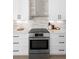 Modern kitchen features white cabinets, light countertops, stainless steel appliances, and a tile backsplash at 1540 Park Forest Blvd, Mount Dora, FL 32757