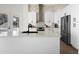 A modern kitchen showcases white cabinets, stainless steel appliances, and a spacious island with a sleek black faucet at 1540 Park Forest Blvd, Mount Dora, FL 32757