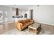 A large open-concept living space featuring the kitchen with stainless appliances and tan leather sofa at 1540 Park Forest Blvd, Mount Dora, FL 32757