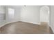Spacious room with neutral walls, light hardwood floors, white trim, and light from the large window at 1540 Park Forest Blvd, Mount Dora, FL 32757
