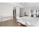 Light-filled main bedroom featuring hardwood floors, a bed with white linens, and access to the outside at 1540 Park Forest Blvd, Mount Dora, FL 32757