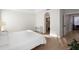 Bright main bedroom featuring hardwood floors, a bed with white linens, and an attached office space at 1540 Park Forest Blvd, Mount Dora, FL 32757