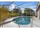Stunning backyard pool surrounded by lush landscaping and a screened enclosure at 1540 Park Forest Blvd, Mount Dora, FL 32757