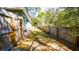 Fenced backyard with a lush green lawn, mature trees, and plenty of privacy at 1602 15Th St, Orange City, FL 32763