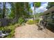 Tranquil backyard with stone patio, mature trees, and comfortable seating at 1628 Bent Oaks Blvd, Deland, FL 32724