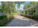 Serene backyard with stone patio, lush landscaping, and sunroom at 1628 Bent Oaks Blvd, Deland, FL 32724