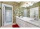 Bathroom featuring a shower, double vanity, and floral wallpaper at 1628 Bent Oaks Blvd, Deland, FL 32724