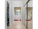 Hallway view of two bathrooms featuring wallpaper, dual sinks, and storage at 1628 Bent Oaks Blvd, Deland, FL 32724