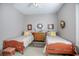 Cozy bedroom with two beds, charming furnishings, and calming gray walls for relaxation at 1628 Bent Oaks Blvd, Deland, FL 32724