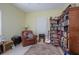Music room with leather chair, floor to ceiling bookshelf and carpeted flooring at 1628 Bent Oaks Blvd, Deland, FL 32724