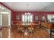 Formal dining room features hardwood floors, wainscoting, shutters, and a chandelier at 1628 Bent Oaks Blvd, Deland, FL 32724