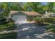 Attractive single-story home featuring a well-maintained lawn, mature landscaping, and a convenient two-car garage at 1628 Bent Oaks Blvd, Deland, FL 32724