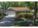 Charming home with well-manicured landscaping, mature trees, an attached garage, and inviting curb appeal at 1628 Bent Oaks Blvd, Deland, FL 32724