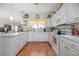 Well-lit kitchen featuring white cabinets, appliances, and a window over the sink at 1628 Bent Oaks Blvd, Deland, FL 32724