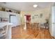 Bright kitchen with white cabinets, stainless refrigerator, and hardwood floors flows into the adjacent dining area at 1628 Bent Oaks Blvd, Deland, FL 32724