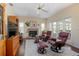 Comfortable living room featuring a fireplace, plush seating, and elegant hardwood floors at 1628 Bent Oaks Blvd, Deland, FL 32724