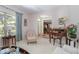Cozy living room featuring a seating area, desk, and large window overlooking the exterior at 1628 Bent Oaks Blvd, Deland, FL 32724