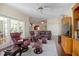 Living area with plush seating, ceiling fan, dark hardwood floors and natural light at 1628 Bent Oaks Blvd, Deland, FL 32724