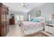 Airy bedroom boasts a ceiling fan, tiled floor, and access to the outside at 1628 Bent Oaks Blvd, Deland, FL 32724