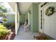 Cozy front porch with rocking chairs and decorative plants, creating a relaxing and inviting outdoor space at 1628 Bent Oaks Blvd, Deland, FL 32724