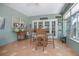 Inviting sunroom with lots of windows, casual dining set, and tile flooring at 1628 Bent Oaks Blvd, Deland, FL 32724