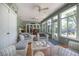 Light-filled sunroom with ample windows, wicker furniture, and tiled floor at 1628 Bent Oaks Blvd, Deland, FL 32724