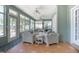 Bright sunroom with multiple seating areas, tile flooring, and lots of natural light at 1628 Bent Oaks Blvd, Deland, FL 32724