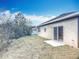 A view of the backyard showing a large green lawn and the back of the house at 1820 18Th St, Orange City, FL 32763