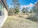 A view of the house's backyard showing a sprawling green lawn and shrubbery at 1820 18Th St, Orange City, FL 32763