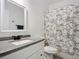 Clean bathroom showcasing a modern vanity, granite countertops, and a shower-tub combo with stylish curtain at 1820 18Th St, Orange City, FL 32763