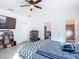 Bedroom featuring a ceiling fan, flat screen TV, and an open bathroom at 1820 18Th St, Orange City, FL 32763