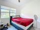Bedroom featuring a window and a bed with a red bed sheet at 1820 18Th St, Orange City, FL 32763