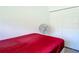Bedroom features a closet, a small fan, and a red bed sheet at 1820 18Th St, Orange City, FL 32763