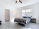 Bright bedroom features a large window, light grey tile flooring, and a ceiling fan at 1820 18Th St, Orange City, FL 32763