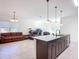 Open concept showcasing the kitchen island, tile floors, and view into the living room at 1820 18Th St, Orange City, FL 32763
