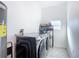 Bright laundry room features modern washer and dryer, plus built in water heater and shelving at 1820 18Th St, Orange City, FL 32763