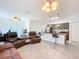 Open-concept living space showcasing tile floors, a ceiling fan and a view of the adjoining kitchen at 1820 18Th St, Orange City, FL 32763