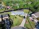 Aerial view of a single-story home with screened in pool on a canal with boat dock at 19 Twin River Dr, Ormond Beach, FL 32174