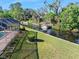 Beautiful lawn leading to a waterfront canal with boat access and an enclosed screened-in pool at 19 Twin River Dr, Ormond Beach, FL 32174