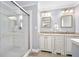 Updated bathroom featuring double sinks, granite counters, and glass shower enclosure at 19 Twin River Dr, Ormond Beach, FL 32174