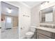Clean bathroom with a decorative toilet, vanity, and access to the laundry area at 19 Twin River Dr, Ormond Beach, FL 32174