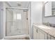Elegant bathroom showcasing a tiled shower with glass door and vanity with granite countertop at 19 Twin River Dr, Ormond Beach, FL 32174