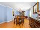 Spacious dining room featuring blue walls, hardwood floors, and a large wood dining table at 19 Twin River Dr, Ormond Beach, FL 32174