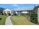 Charming single-story home with a well-manicured lawn and colorful flower beds at 19 Twin River Dr, Ormond Beach, FL 32174