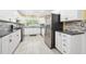 Modern kitchen featuring white cabinets, stainless steel appliances, and granite countertops at 19 Twin River Dr, Ormond Beach, FL 32174