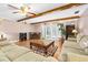 Bright living room features ceiling fan, fireplace, hardwood floors, and French doors to the patio at 19 Twin River Dr, Ormond Beach, FL 32174
