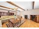 Comfortable living room with hardwood floors, wooden beams, and entertainment center at 19 Twin River Dr, Ormond Beach, FL 32174