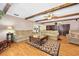 Large living room with wooden beams, hardwood floors, and an open view to the kitchen at 19 Twin River Dr, Ormond Beach, FL 32174